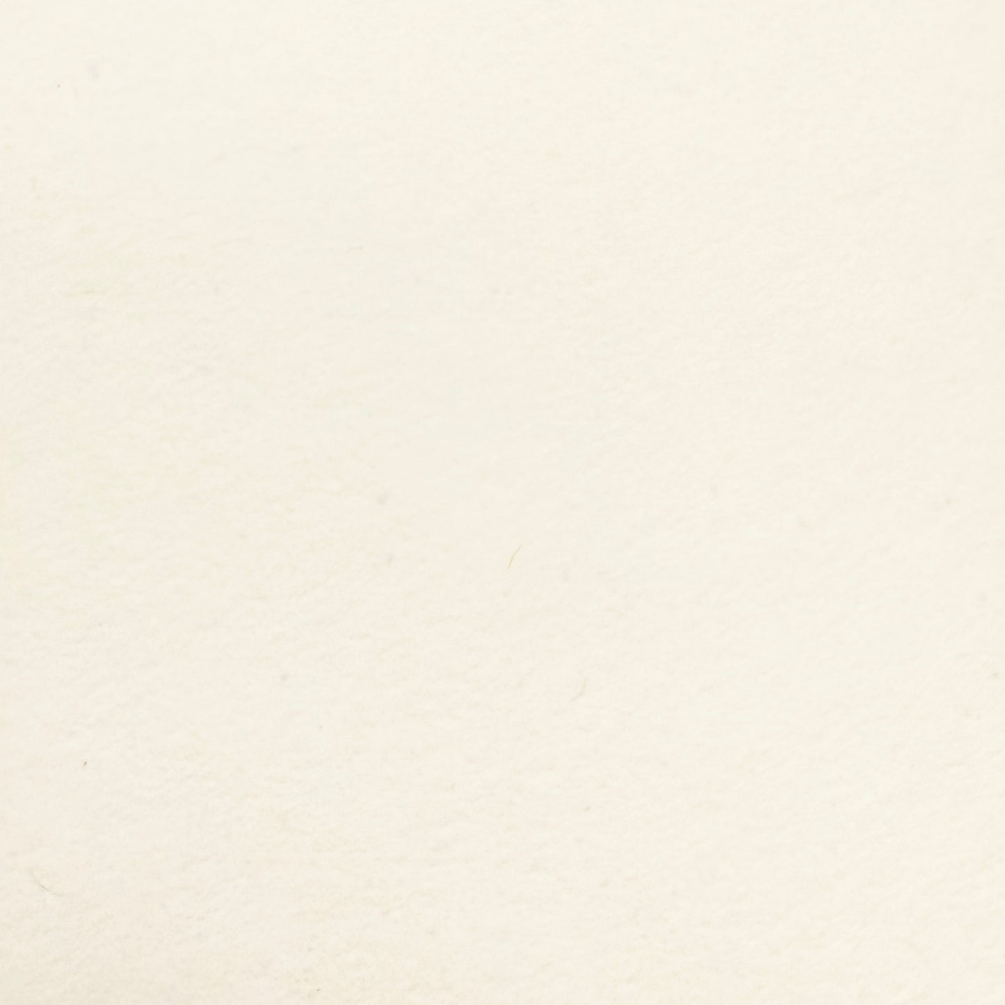 Swatch of cream wallpaper made with recycled materials