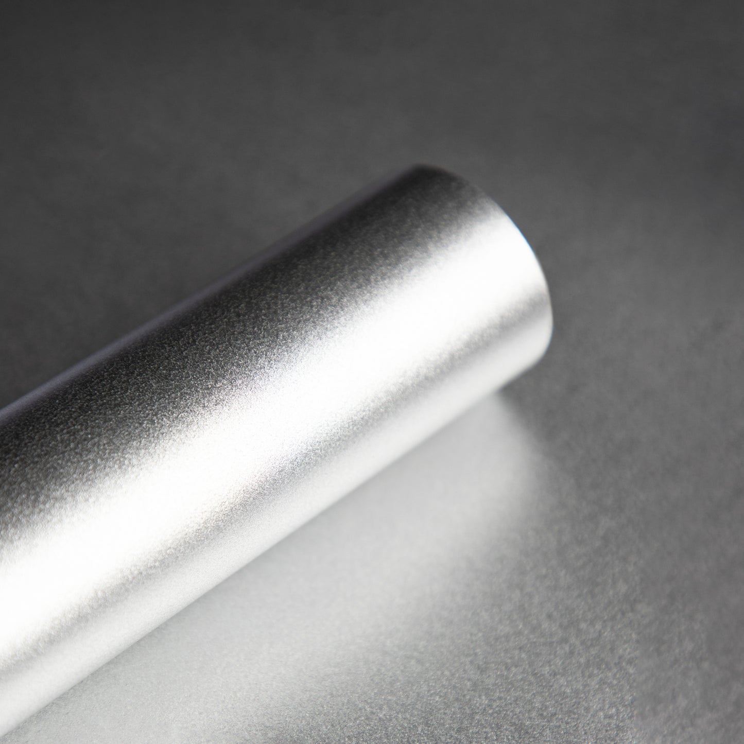 Roll of smooth silver wallpaper