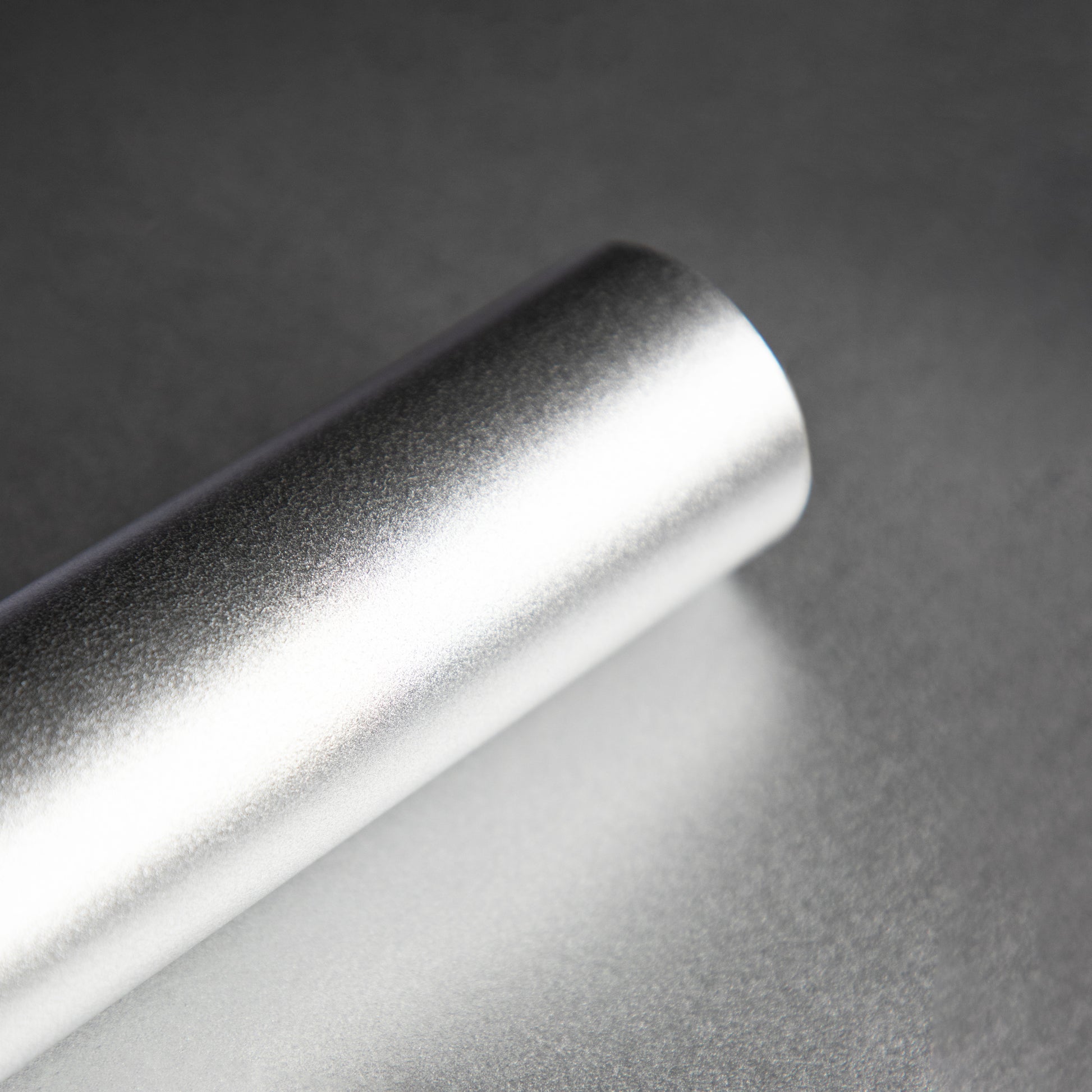 Roll of smooth silver wallpaper