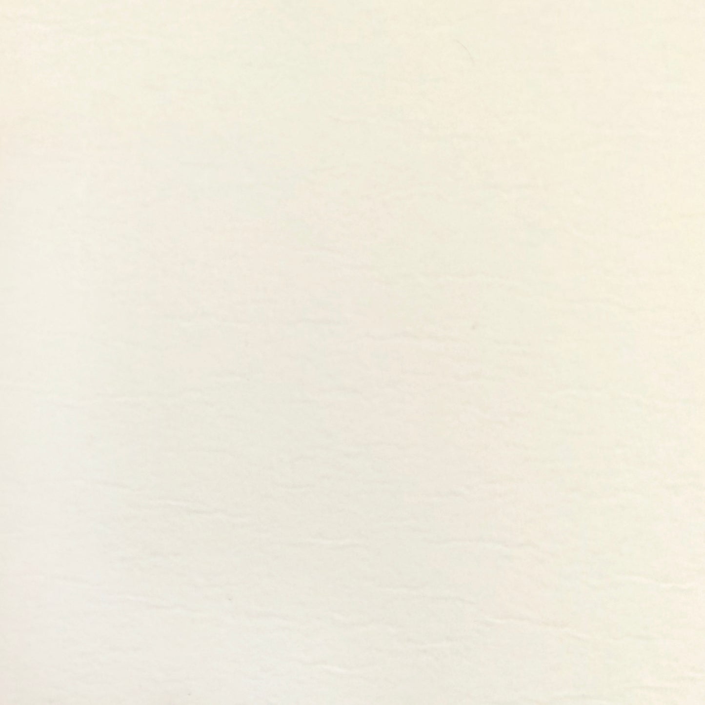 Swatch of smooth cream wallpaper with removable adhesive