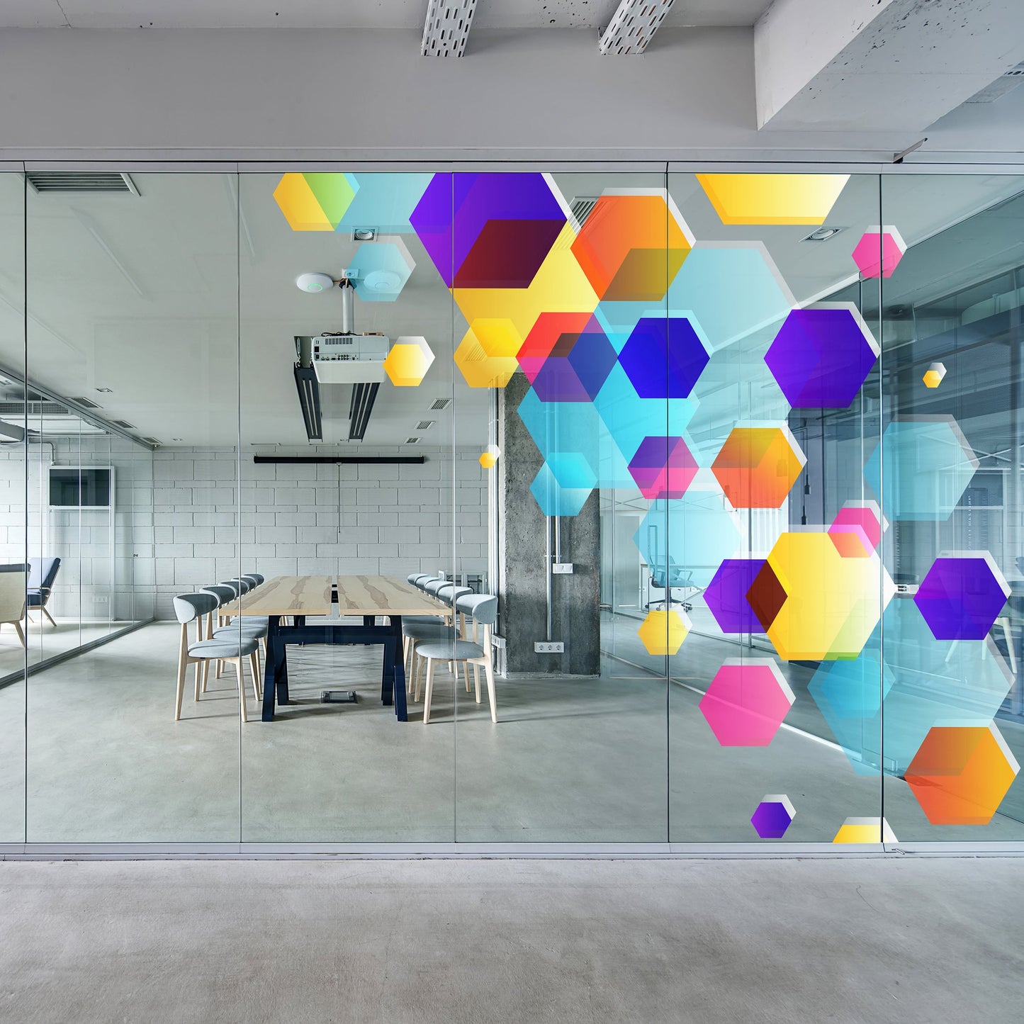 Modern office with colorful geometric art on glass walls