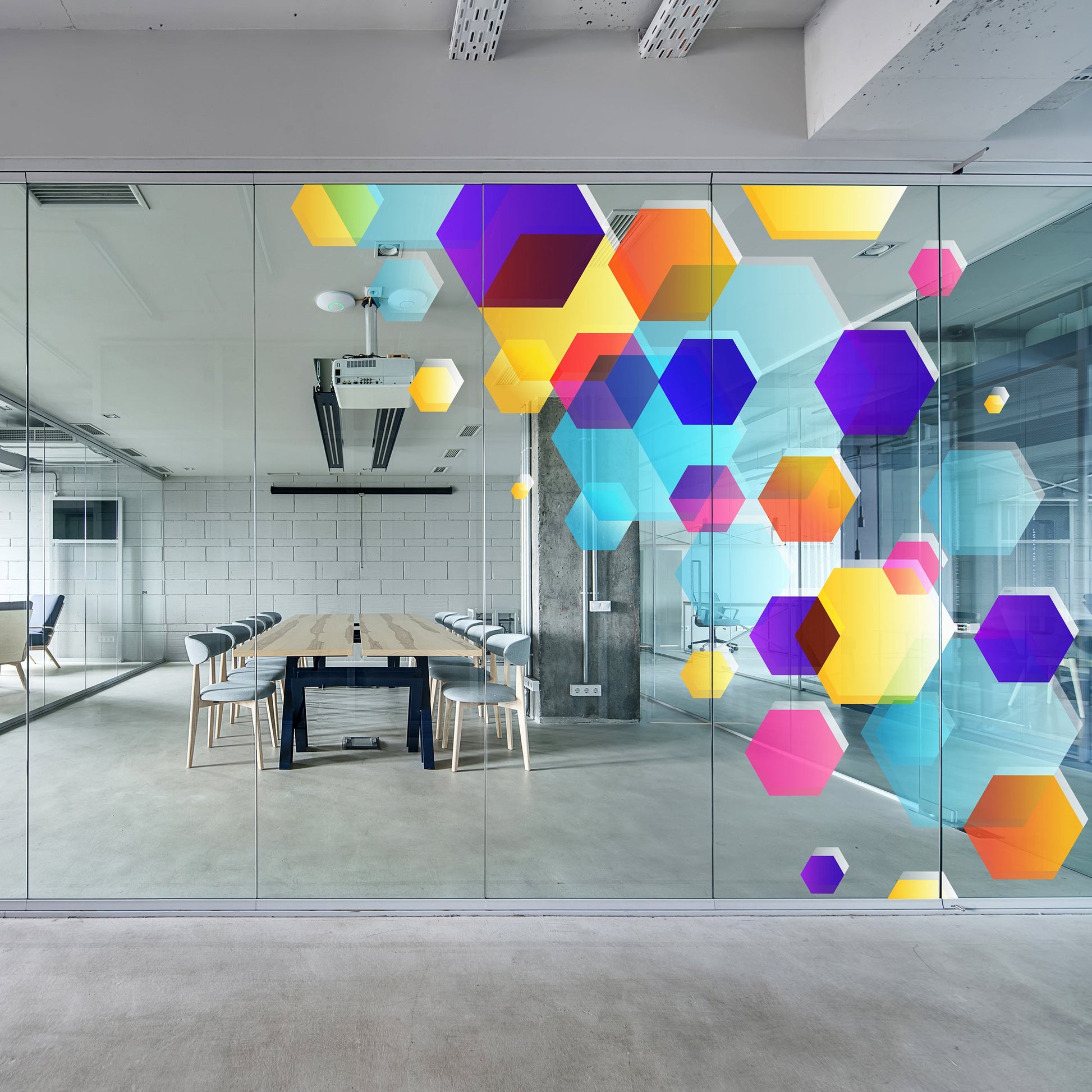 Modern office with colorful geometric art on glass walls